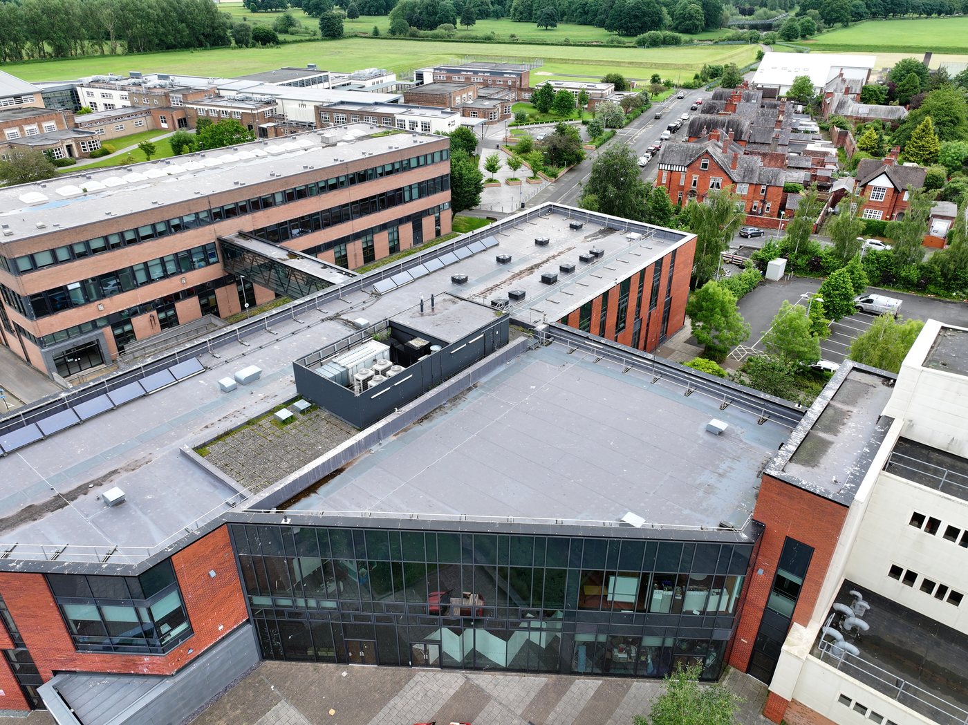 Aerial drone survey of a multi-roof educational estate -- the kind of programme Solar Surveys prices in its commercial drone roof survey cost guide.