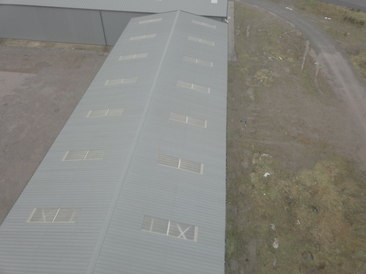 Aerial of a long-span industrial warehouse roof assessed by Solar Surveys for east-west solar array structural loading versus south-facing arrays