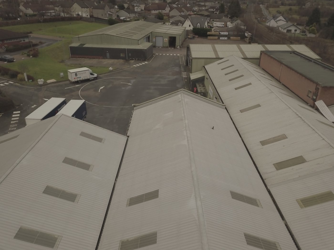 Aerial of a long-span industrial warehouse, the kind of long-life commercial asset where PPA providers commission Solar Surveys' fast structural reports