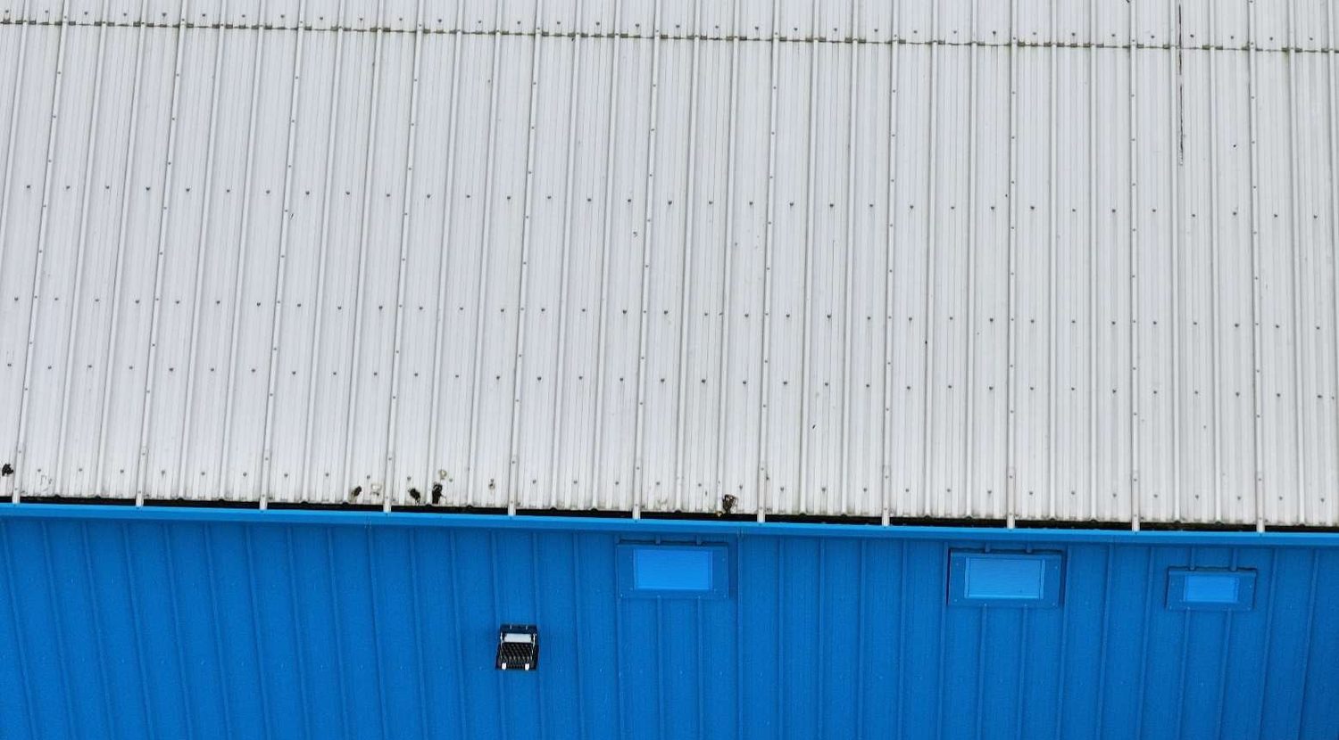 Trapezoidal corrugated metal roof sheeting on an industrial unit assessed at the margin of its allowable capacity