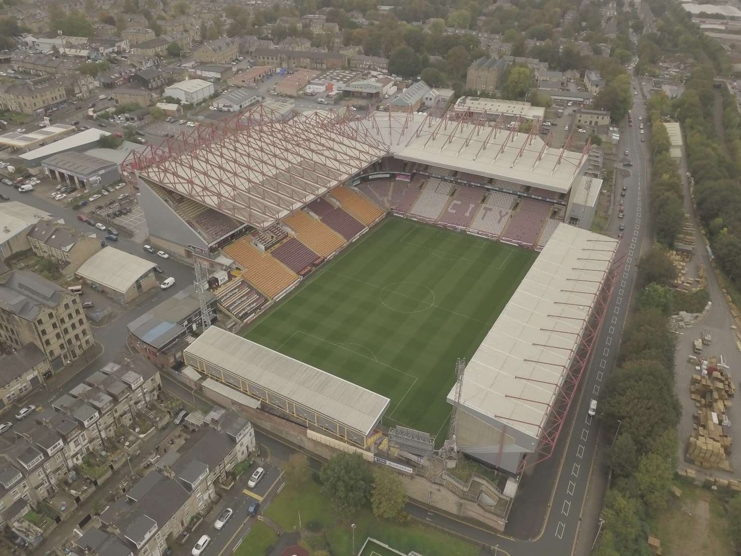 Aerial drone view of a football stadium with monopitch stand roofs surveyed for covering condition