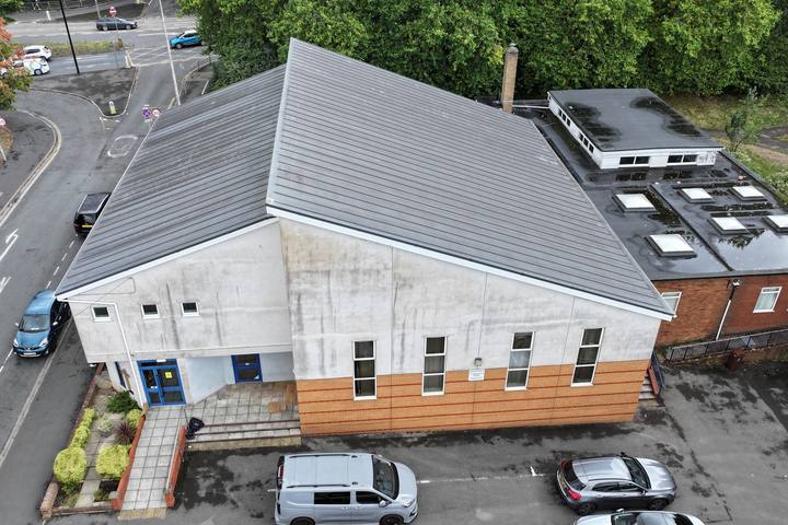 Monopitch hall with standing seam roof and adjoining flat roofs
