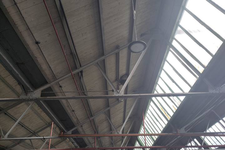 Steel roof trusses under a sawtooth roof with glazing